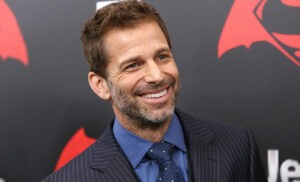Zack Snyder is smiling for a photo.